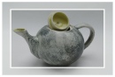 yellow ceramic teapot with upturned lid